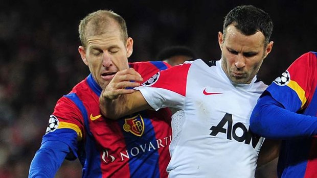 Mixing it with the best ... Scott Chipperfield challenges Ryan Giggs of Manchester United during FC Basel's Champions League clash in December.