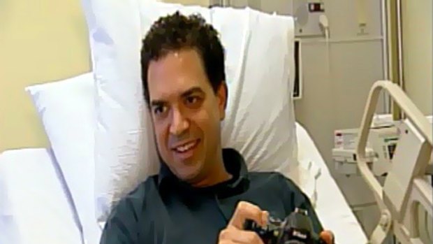 Dan Woolley, with his trusty digital SLR camera, recovers in hospital.