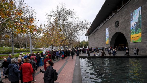 Crowds wait outside the NGV.