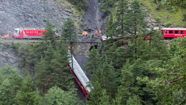 A derailed passenger train is pictured near Tiefencastel, Switzerland.
