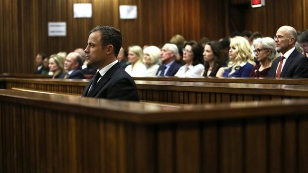 Oscar Pistorius listens to Judge Thokozile Masipa (unseen) deliver her verdict.