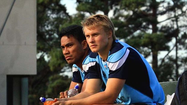 Wing rivals ... Atieli Pakalani (L) and Tom Kingston look on during the Waratahs training session in Cape Town on Thursday.