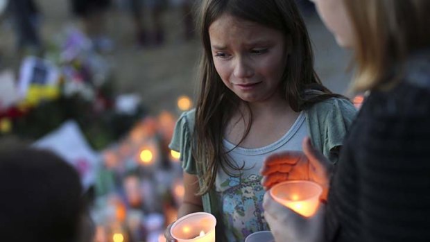 Denae Kirtley lights a candle at the site where Andy was killed in Santa Rosa, California.