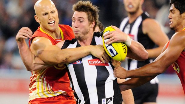 Not having it ... Collingwood's Dale Thomas, centre, made a complaint about the incident.