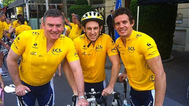 Luke Ball (right) and Eddie McGuire (left) don yellow jerseys on the Tour de France route last year.
