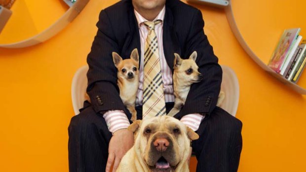 Holding on ... Ian Lazar (who did not wish to be identified) with the three dogs he owns that were not kidnapped. Thieves are demanding a ransom of $300,000.