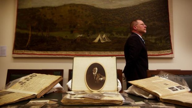 Kevin Morgan at the State Library with some of Frederick Piggott's scrapbooks.
