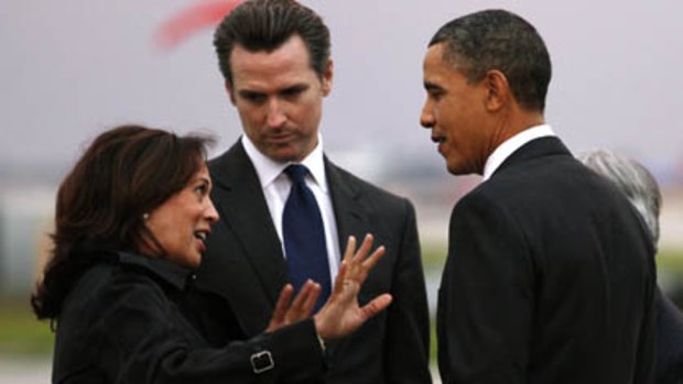 US President Barack Obama is greeted by California Attorney General Kamala Harris and California Lieutenant Governor Gavin Newsom upon his arrival in San Francisco.