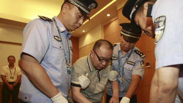 Lai Changxing (centre) has been jailed over his $3 billion smuggling ring.