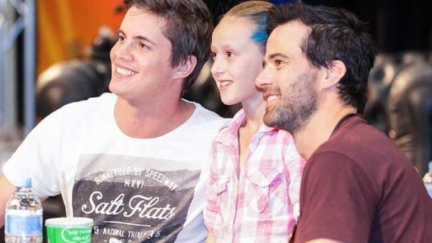 Johnny Ruffo and Charlie Clausen pose for a photo with a young admirer.
