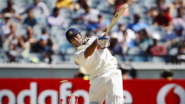 India's captain Mahendra Singh Dhoni swings lustily and loses his wicket.