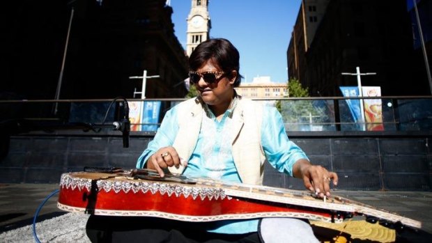 Debashish Bhattacharya performs for morning commuters in Martin Place.