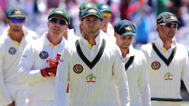 Long faces after one of the shortest Test innings on record ... captain Michael Clarke leads his Australian team from the field at Newlands, Cape town, after its humiliating defeat to South Africa.