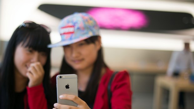 Checking out an iPhone 6 in an Apple store in Shanghai.