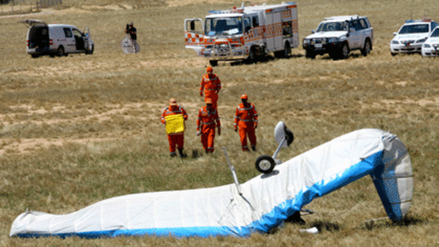 Emergency service personnel at the site of the fatal ultralight crash.