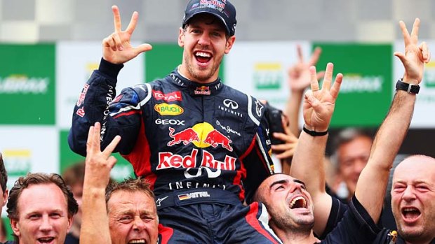 Three cheers: Sebastian Vettel and his Red Bull teammates celebrate his title win.