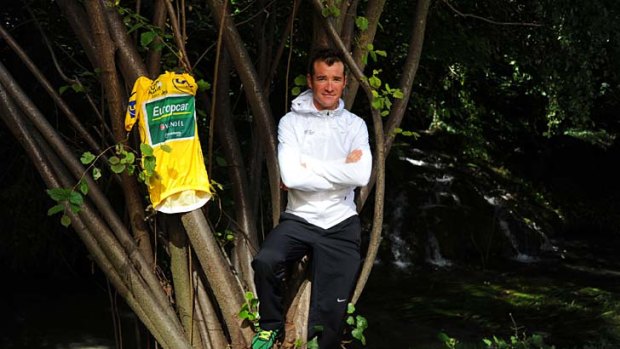 Thomas Voeckler poses with his jersey near a waterfall in Valence, southern France, on the second rest day of the Tour.