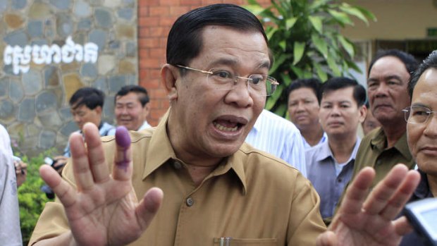 Cambodian Prime Minister Hun Sen gestures after casting his ballot in local elections at Ta Khmau town, in Kandal province, some 15 kilometers south of Phnom Penh, Cambodia.