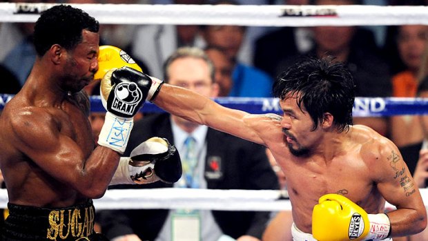 Manny Pacquiao (right) lands a blow in the seventh round of his WBO welterweight title fight with Shane Mosley.