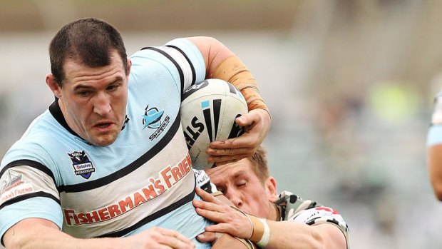 Paul Gallen of the Sharks ploughs into the Raiders defence.
