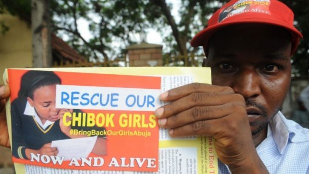 Protest: A Nigerian man holds a flyer campaigning for the release of 276 missing girls.