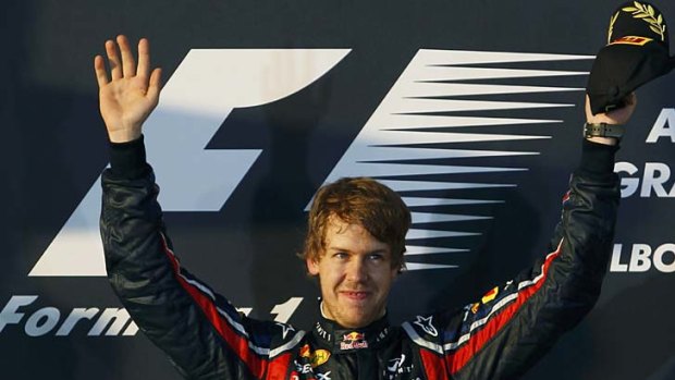 Sebastian Vettel waves from the podium after winning the Australian F1 Grand Prix.