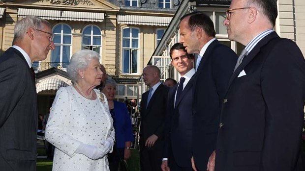 Prime Minister Tony Abbott meets Queen Elizabeth II at an exclusive party on the eve of D-Day commemorations in France.