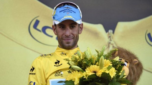 Italy's Vincenzo Nibali celebrates his overall leader yellow jersey on the podium at the end of the 161.50-km tenth stage.