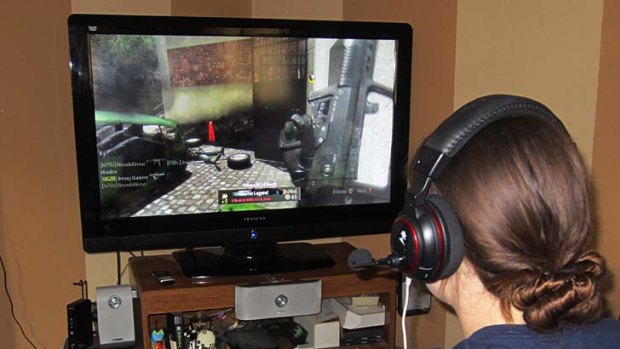 A girl uses an Xbox to play a game.