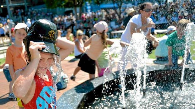 Kids cool down by the fountain at the Australian Open.