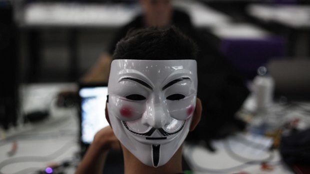 A hacker with a Guy Fawkes mask, a symbol linked to the Anonymous hacking movement.