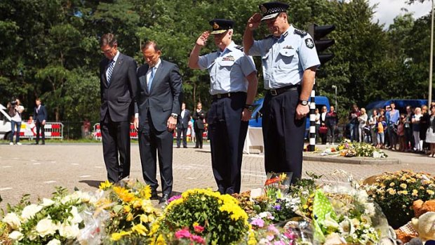 Remember them: Tony Abbott with special envoy Angus Houston, defence chief Mark Binskin and AFP commissioner Tony Negus with tributes to the MH17 victims.