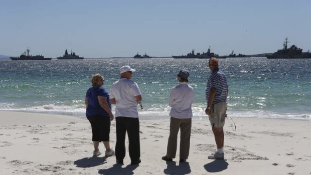 The fleet's in: Beachgoers admire the ships gathering in Jervis Bay.