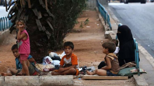 Homeless Syrian refugees rest by a road in Beirut, Lebanon. More than 1.7 million Syrians have fled to nearby countries to escape the civil war.