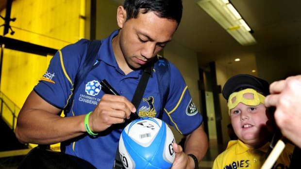 Homecoming: Christian Lealiifano greets a fan after arriving back in Australia.