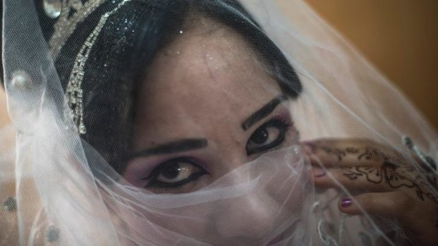 Noor, who is about 16, at a beauty salon on her wedding day in the Zaatari camp.