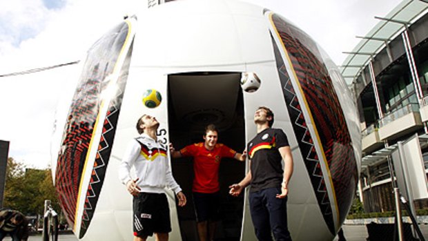 Adam Santarossa (middle), Sam Lonergan (left) and Jobe Watson get into World Cup mode yesterday.
