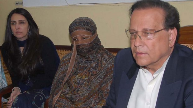 Asia Bibi, centre, listens to the then Pakistani Punjab province governor, the late Salman Taseer.