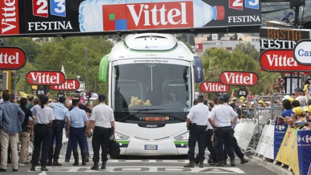 Blunder: officials gather around the GreenEDGE tour bus after it gets stuck under the finish gantry in Bastia.