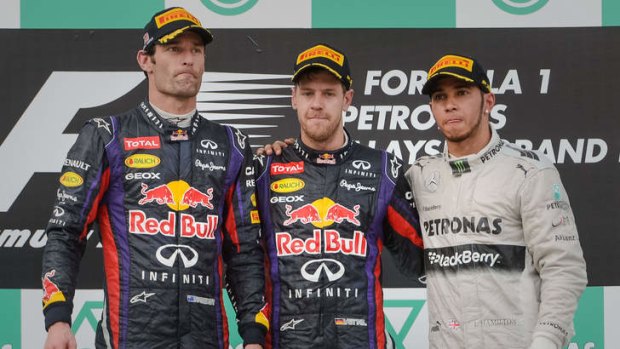 Unhappy scene: Webber, Vettel and Hamilton on a gloomy podium.