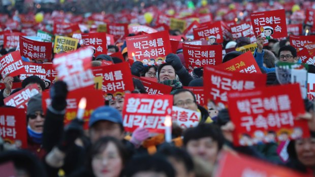 Signs reading 'Arrest, Park Geun-hye' during protests in Seoul on Saturday.