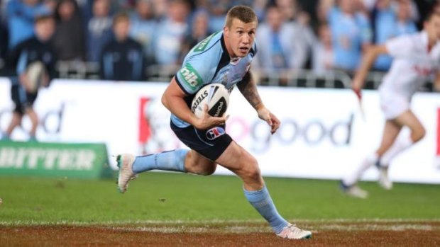 Match-winner: Trent Hodkinson beats the Maroons defenders to dive over for NSW.