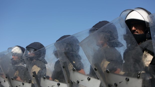 Afghan police block a road in Kabul ahead of the massive protest march.