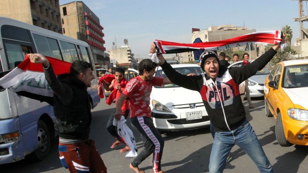 Something to really cheer about ... Iraqi men celebrate the Asian Cup victory in the streets of Baghdad.