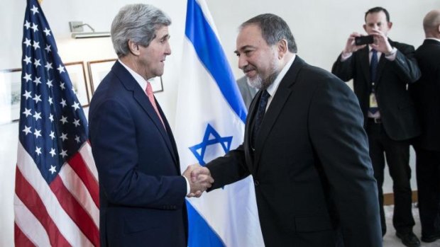 Israeli Foreign Minister Avigdor Lieberman (right) greets US Secretary of State John Kerry (left) ahead of their meeting in Jerusalem. 