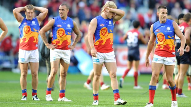 Disappointment: Brisbane Lions players after their loss to the Demons last season.