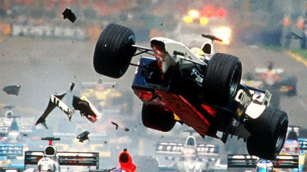 Williams team driver Ralf Schumacher from Germany flies through the air over the top of Ferrari driver Rubens Barrichello of Brazil at the start of the Australian Formula One Grand Prix in Melbourne March 3, 2002. Ferrari team driver Michael Schumacher from Germany won the race ahead of Williams team driver Juan Pablo Montoya from Colombia and McLaren team driver Kimi Raikkonen from Finland third. REUTERS/Joe Mann ***FOR EDITORIAL USE ONLY***