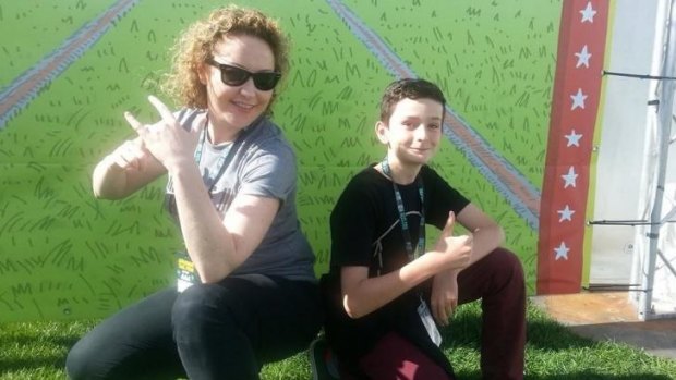 Triple j DJ Zan Rowe handed over to Canberra year six student Rhys Toms at Sunday's Groovin the Moo.