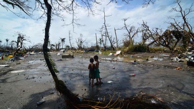 Two boys take in the devastation wreaked by typhoon Haiyan in Tacloban.