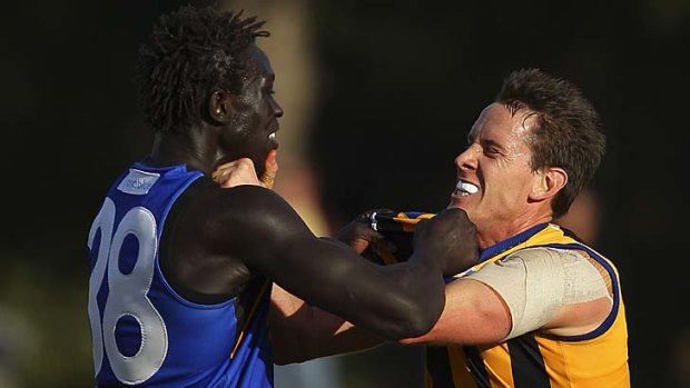 Majak Daw of the Tigers wrestles with Jason Blake of the Zebras.